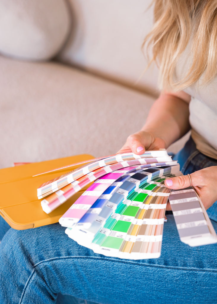 Beth holding Pantone swatches and choosing a colour.